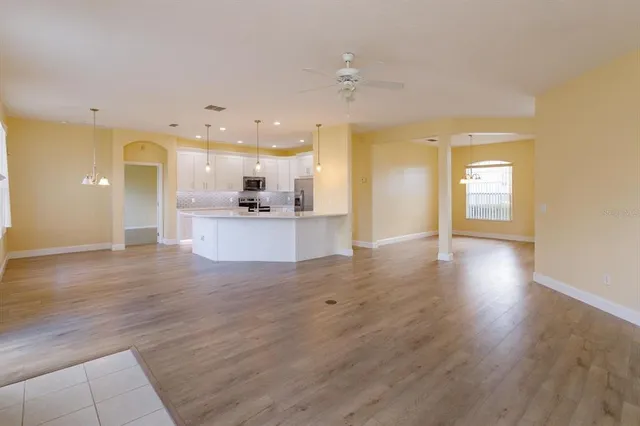 a view of a kitchen with a sink and a refrigerator