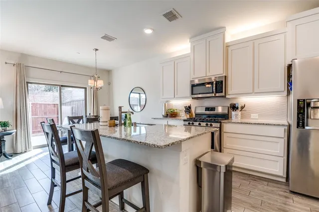 a kitchen with refrigerator a stove and furniture