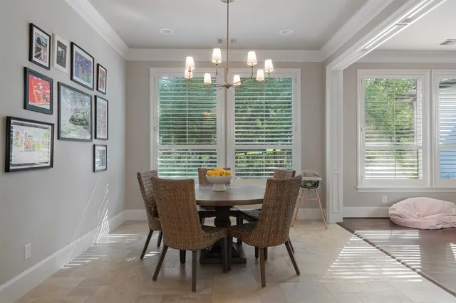 a dining room with furniture a chandelier and window