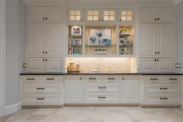 a view white cabinets and wooden floor