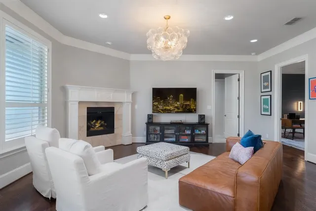 a living room with furniture a fireplace and a flat screen tv