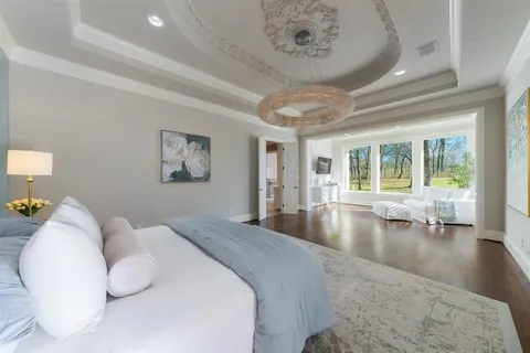 a spacious bedroom with a large bed and a large window