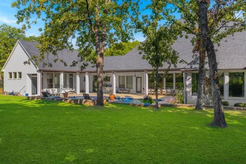 a front view of a house with backyard garden and patio