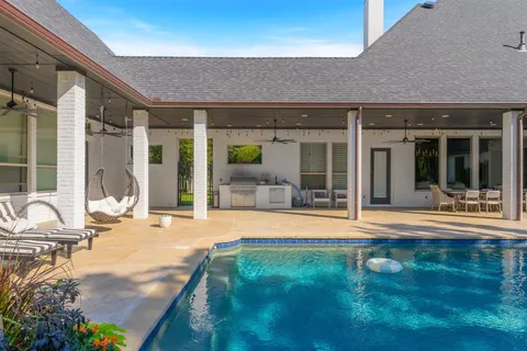 a swimming pool with patio outdoor seating and yard