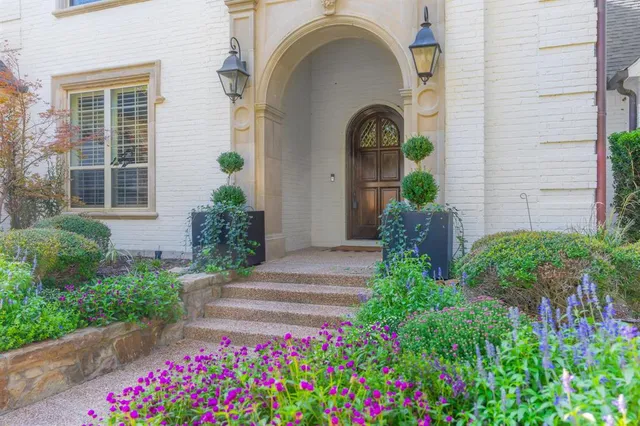 a front view of a house with potted plants