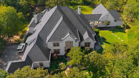 an aerial view of house with a yard and swimming pool