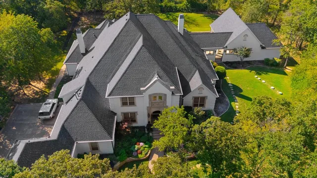 an aerial view of house with a yard and swimming pool