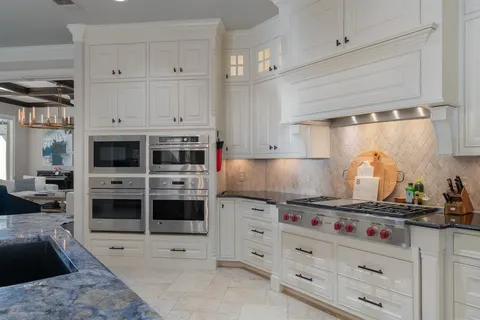 a kitchen with stainless steel appliances a stove and cabinets
