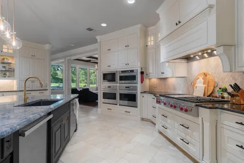 a kitchen with stainless steel appliances granite countertop a stove and a sink