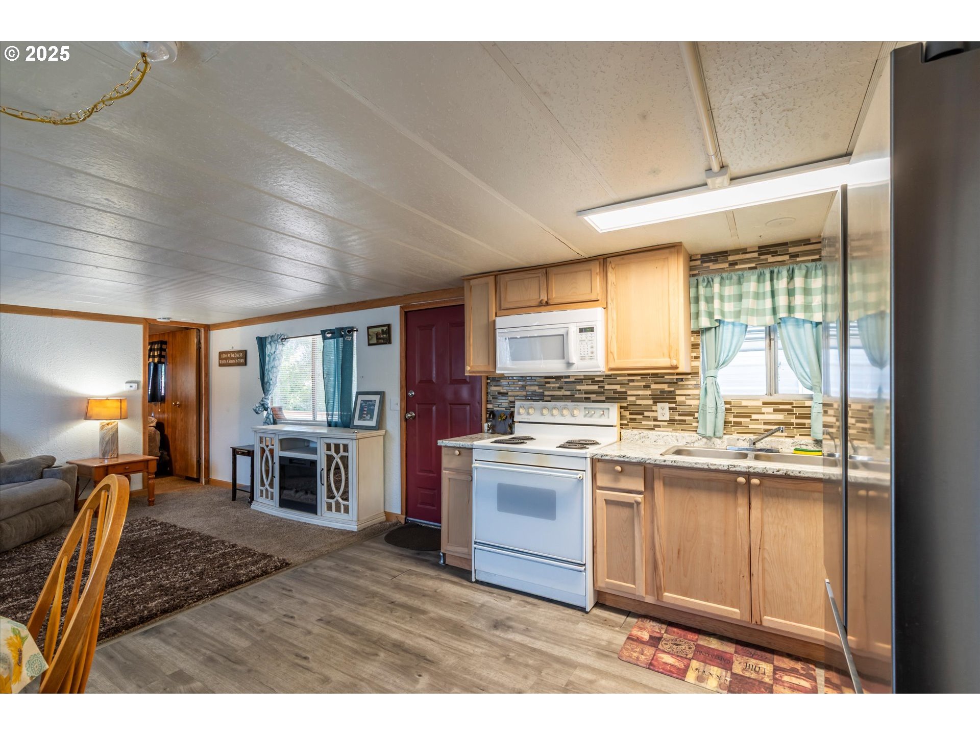 125 North 4th Street Lakeside, OR 97449 - Photo 13 of 38 a kitchen with a stove a refrigerator and a sink