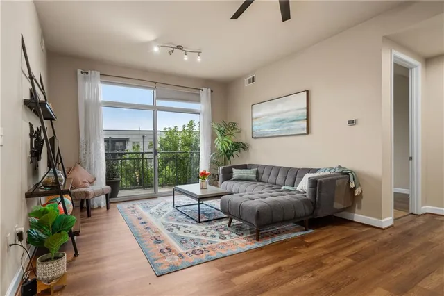 a living room with furniture and a floor to ceiling window