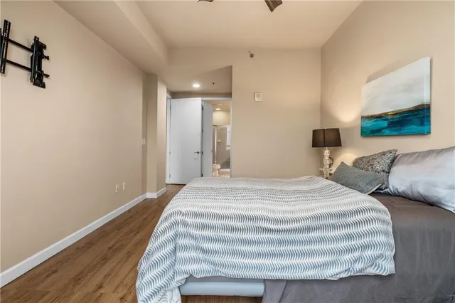 a bedroom with a bed and a painting on the wall