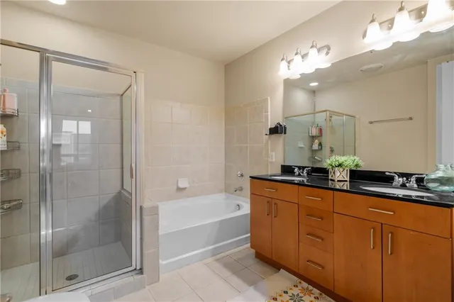 a bathroom with a tub sink and mirror