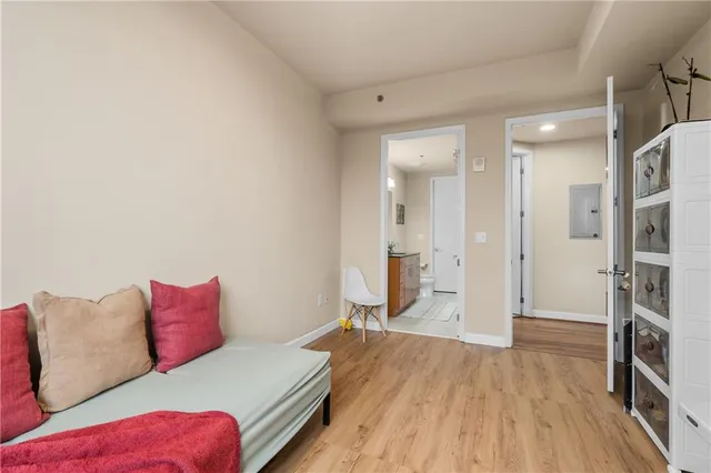 a bedroom with a bed and a wooden floor