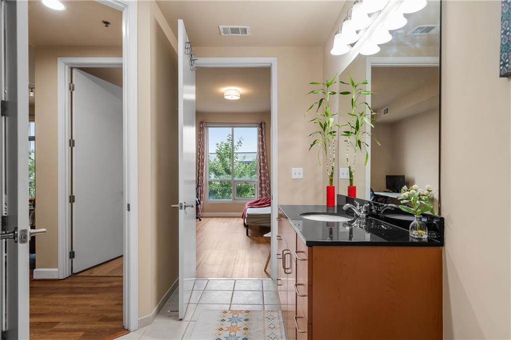 711 Cosmopolitan Drive Northeast, Unit 517 Atlanta, GA 30324 - Photo 20 of 29 a dining room with furniture and chandelier