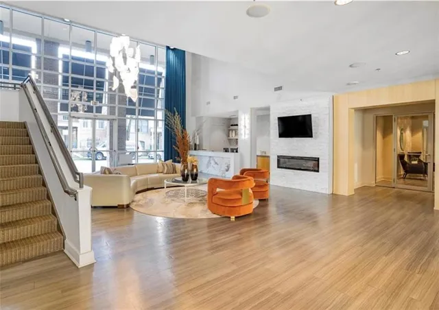 a living room with furniture and a wooden floor
