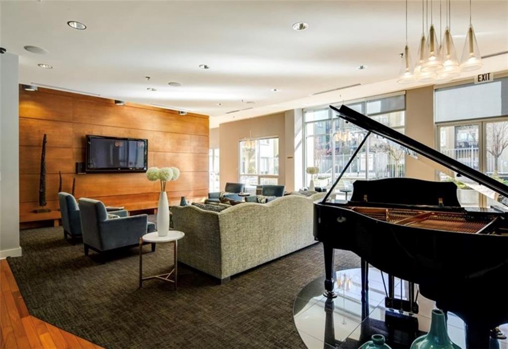 711 Cosmopolitan Drive Northeast, Unit 517 Atlanta, GA 30324 - Photo 23 of 29 a living room with furniture and a flat screen tv
