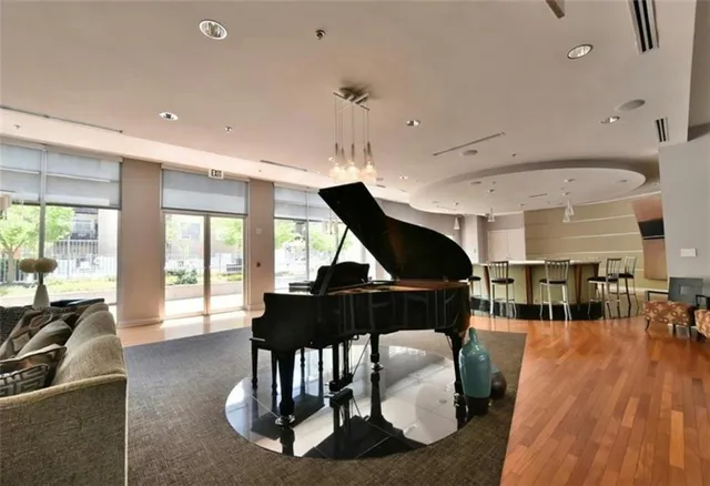 a living room with furniture a wooden floor and a chandelier