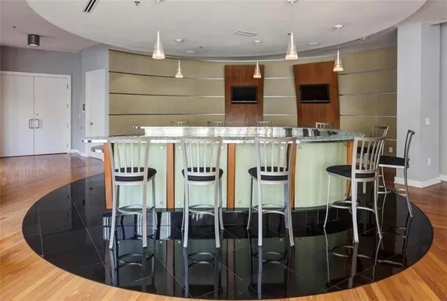 a kitchen with stainless steel appliances kitchen island granite countertop a sink and cabinets