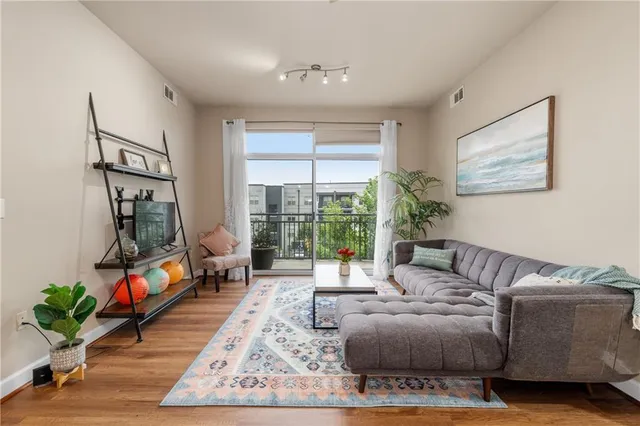 a living room with furniture and a potted plant