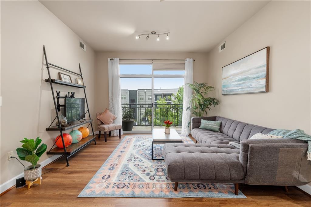 711 Cosmopolitan Drive Northeast, Unit 517 Atlanta, GA 30324 - Photo 6 of 29 a living room with furniture and a potted plant