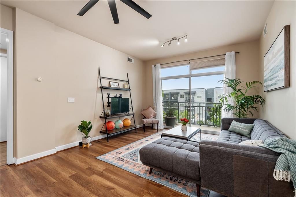 711 Cosmopolitan Drive Northeast, Unit 517 Atlanta, GA 30324 - Photo 7 of 29 a living room with furniture tv and a window