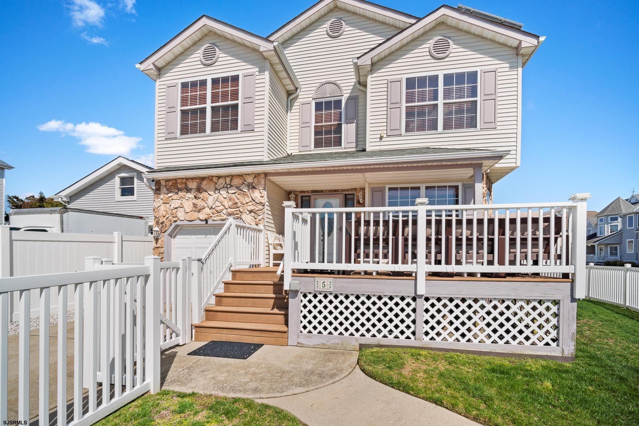 a view of a house with wooden deck and deck