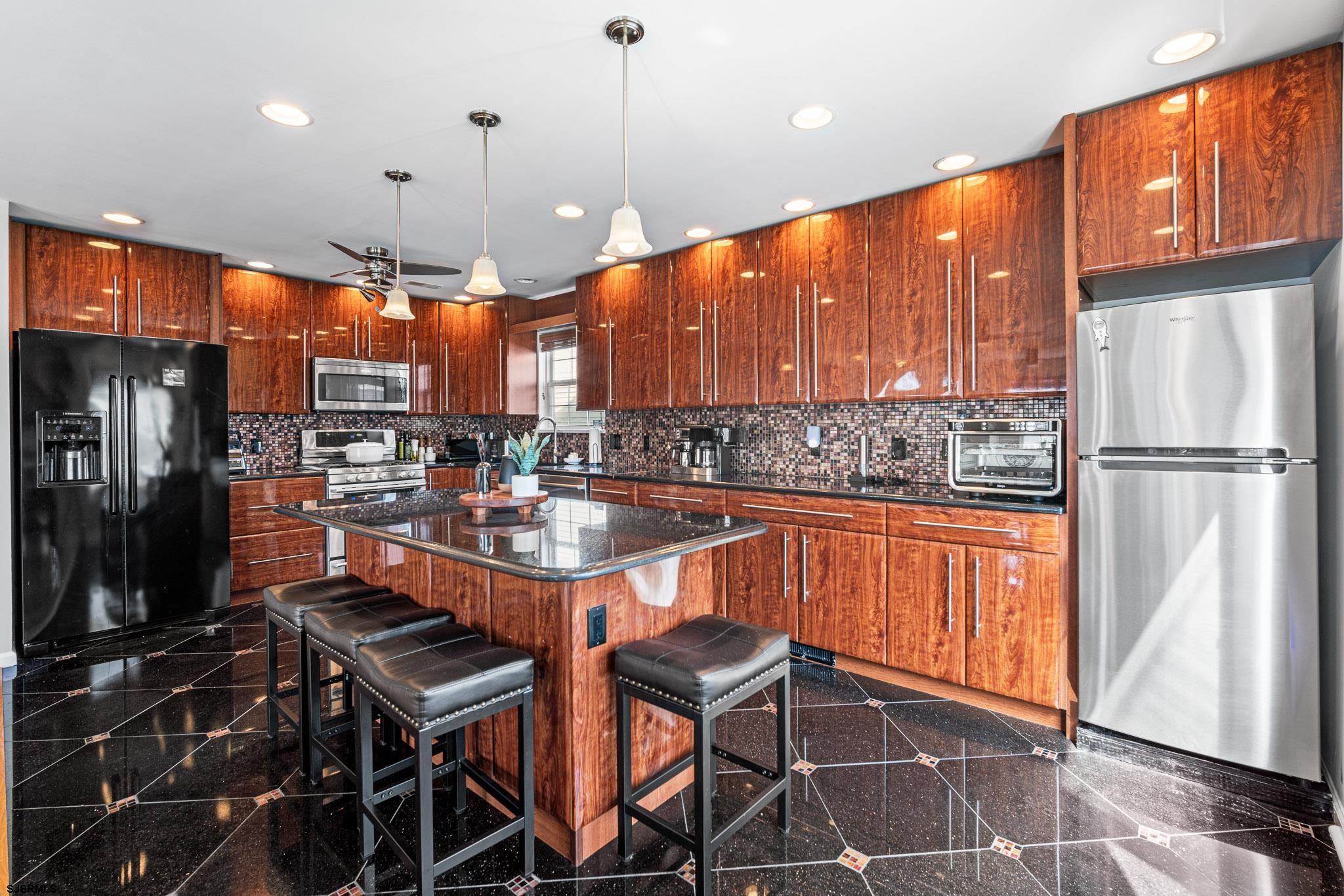 5 Collette Circle Brigantine, NJ 08203 - Photo 13 of 36 a kitchen with stainless steel appliances granite countertop a sink refrigerator and cabinets