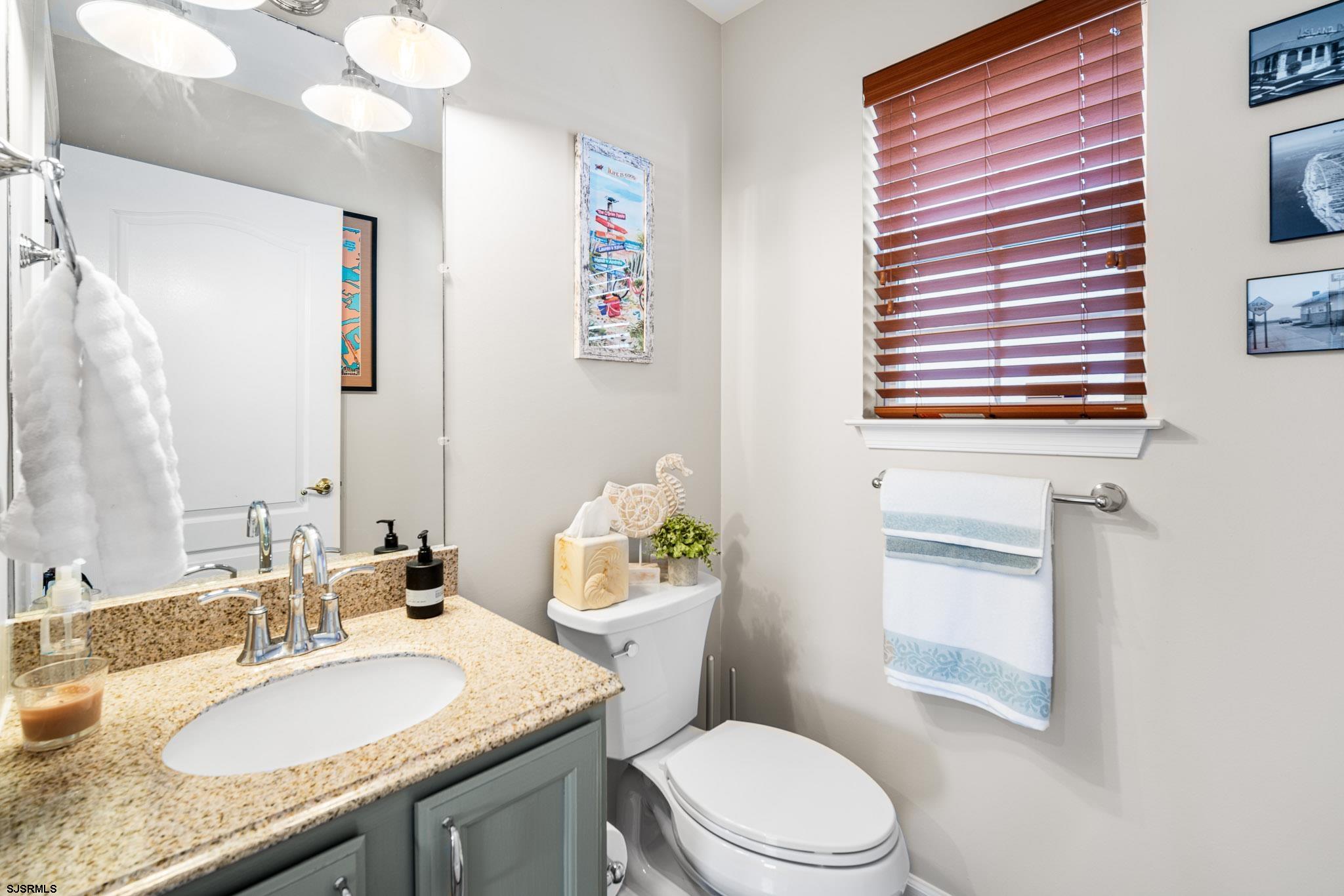 5 Collette Circle Brigantine, NJ 08203 - Photo 14 of 36 a bathroom with a granite countertop toilet sink and mirror