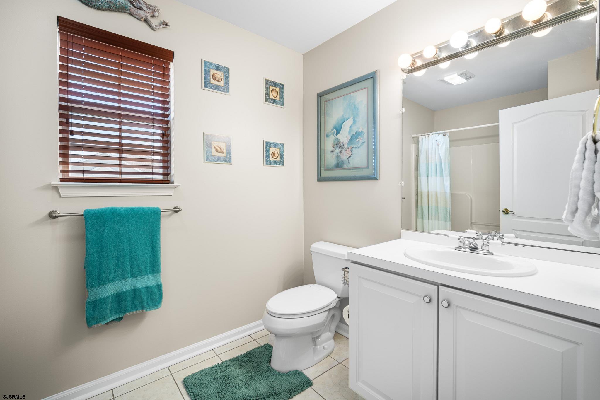5 Collette Circle Brigantine, NJ 08203 - Photo 19 of 36 a bathroom with a toilet a sink and a mirror