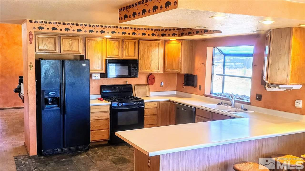 2440 Lousetown Road Reno, NV 89521 - Photo 3 of 20 a kitchen with a refrigerator and a sink