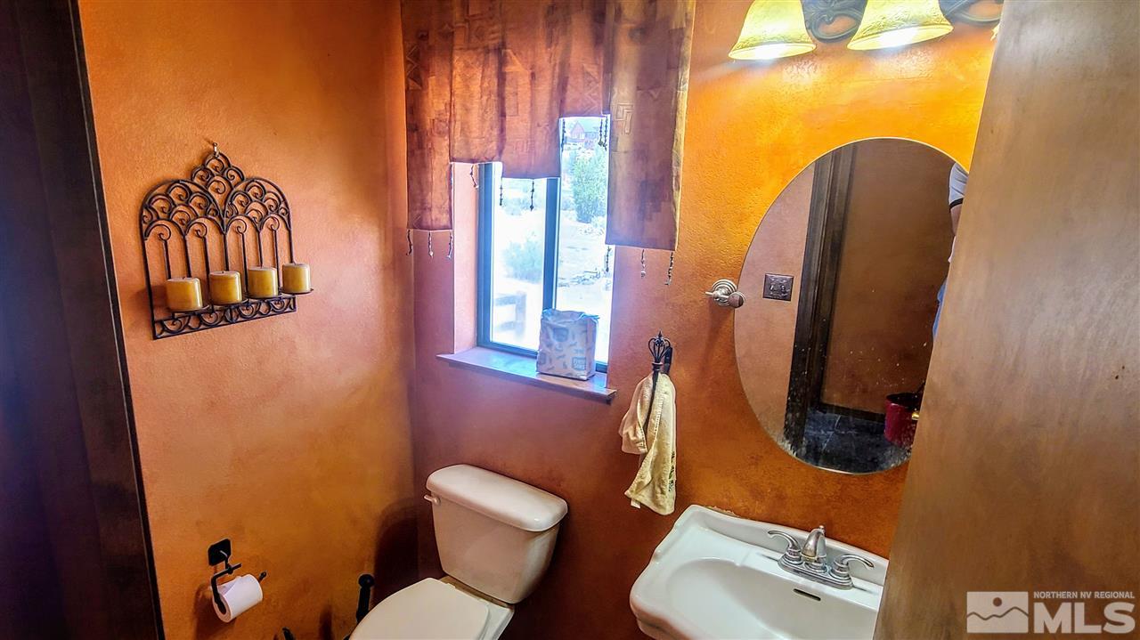 2440 Lousetown Road Reno, NV 89521 - Photo 9 of 20 a bathroom with a toilet sink and mirror
