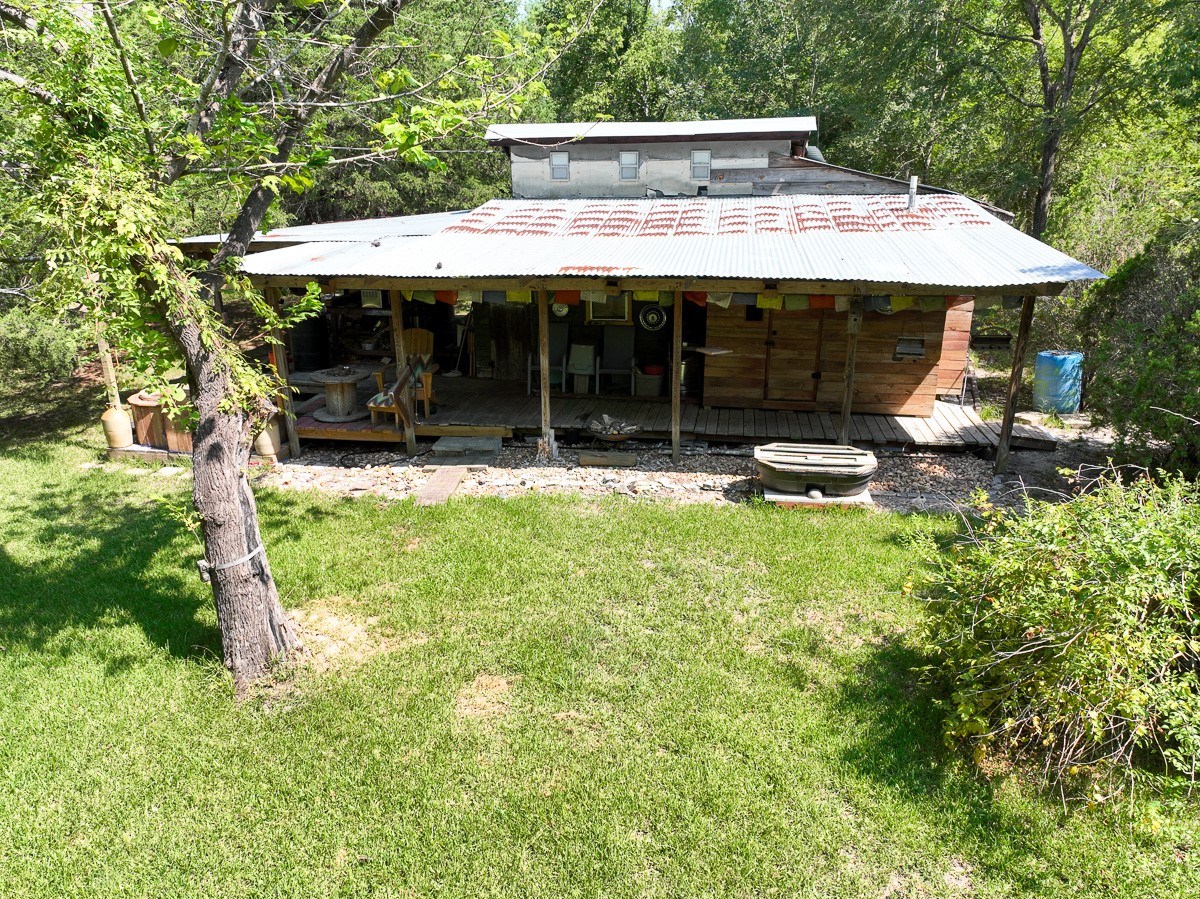 0 Fm 1374 Huntsville, TX 77340 - Photo 6 of 18 a patio with table and chairs under an umbrella