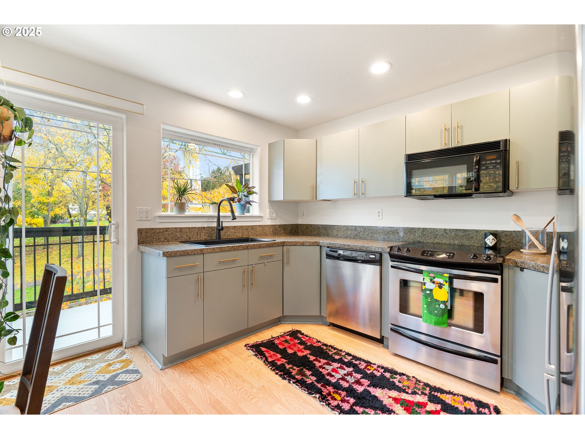 6700 North Pittsburg Avenue Portland, OR 97203 - Photo 5 of 29 a kitchen with stainless steel appliances kitchen island granite countertop a stove top oven a sink and a granite counter top