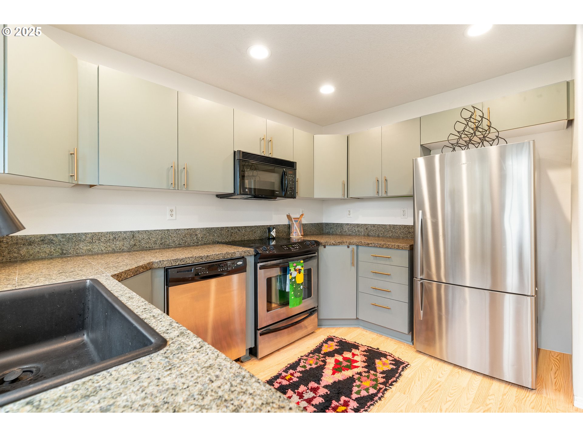 6700 North Pittsburg Avenue Portland, OR 97203 - Photo 7 of 29 a kitchen with stainless steel appliances granite countertop a refrigerator stove and sink