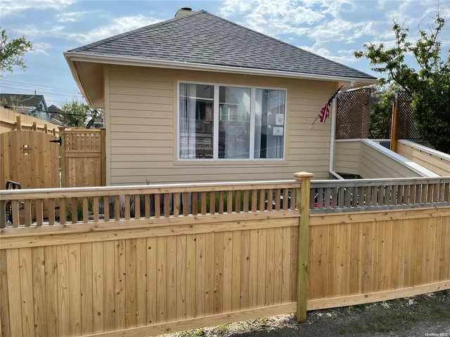 a view of a house with wooden fence