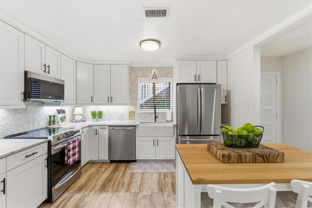 2907 Ironwood Road Southeast Marietta, GA 30067 - Photo 1 of 41 a kitchen with a refrigerator sink and white cabinets