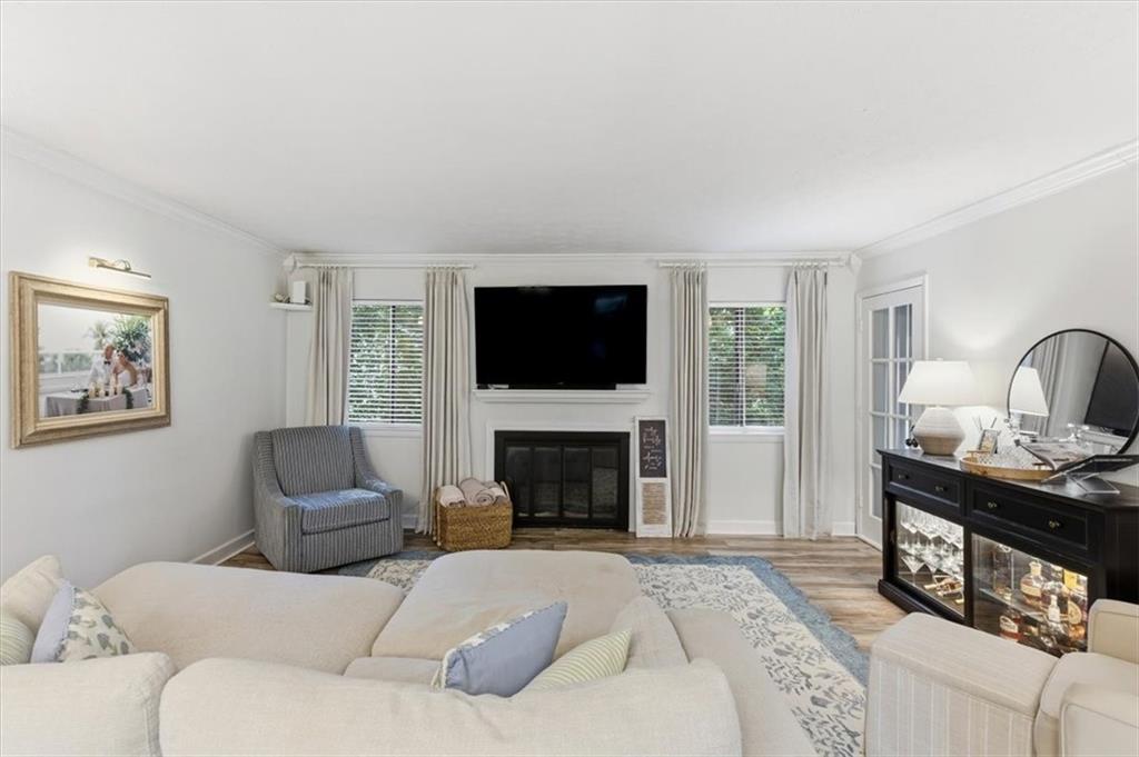 2907 Ironwood Road Southeast Marietta, GA 30067 - Photo 15 of 41 a living room with furniture a fireplace and a flat screen tv