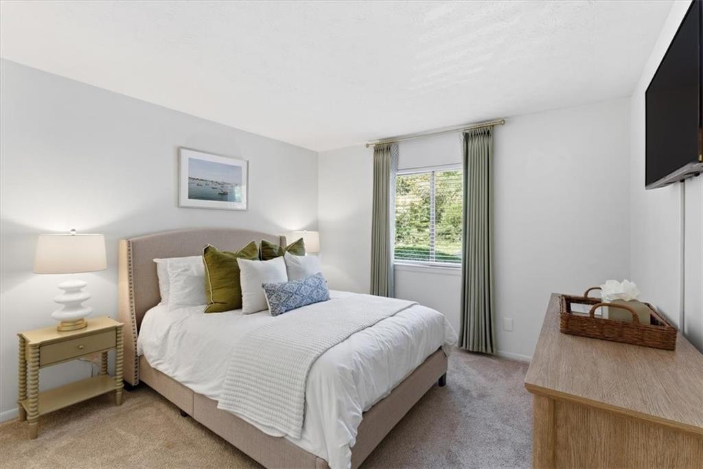 2907 Ironwood Road Southeast Marietta, GA 30067 - Photo 22 of 41 a bedroom with a bed and a flat tv screen on a dresser