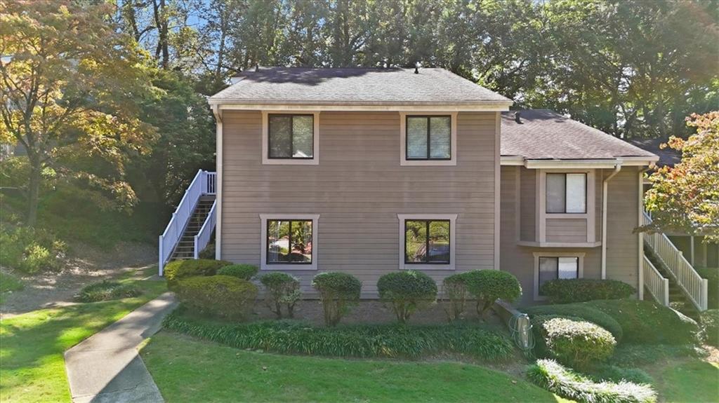 2907 Ironwood Road Southeast Marietta, GA 30067 - Photo 30 of 41 a brick house with a yard plants and large trees