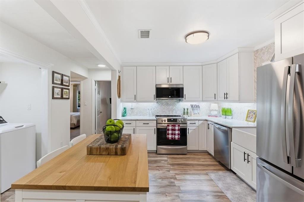 2907 Ironwood Road Southeast Marietta, GA 30067 - Photo 6 of 41 a kitchen with stainless steel appliances granite countertop a refrigerator a stove top oven a sink and dishwasher