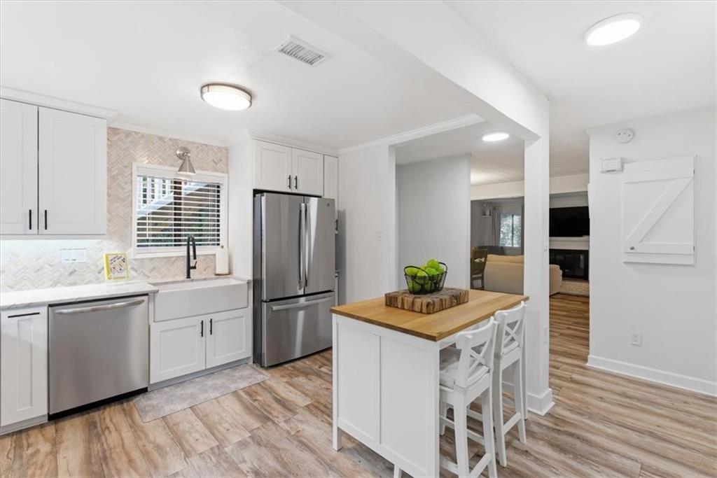 2907 Ironwood Road Southeast Marietta, GA 30067 - Photo 9 of 41 a kitchen with stainless steel appliances kitchen island granite countertop a refrigerator and a stove top oven