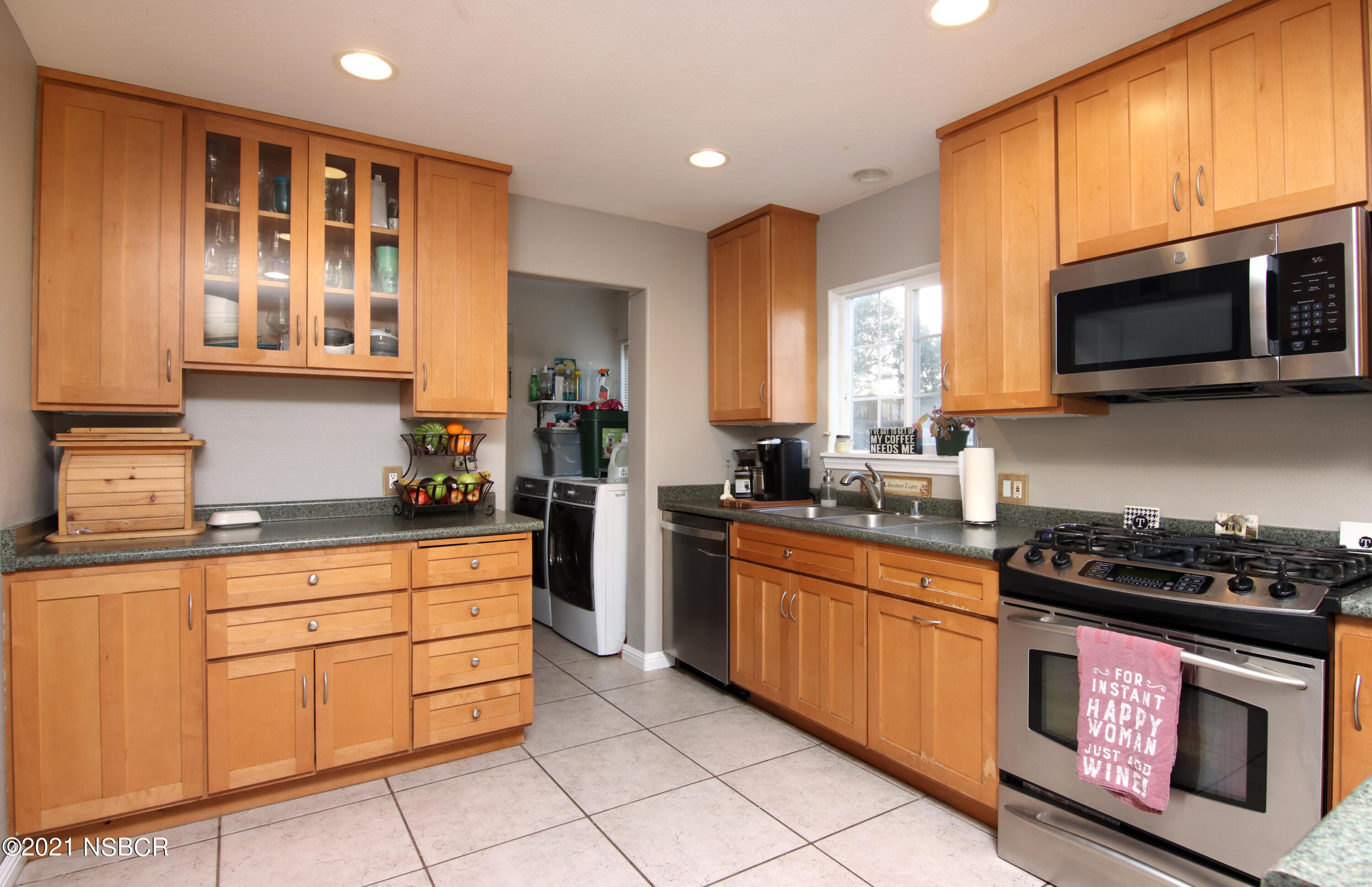 492 Milky Way Lompoc, CA 93436 - Photo 9 of 27 a kitchen with stainless steel appliances granite countertop a stove a sink and a microwave