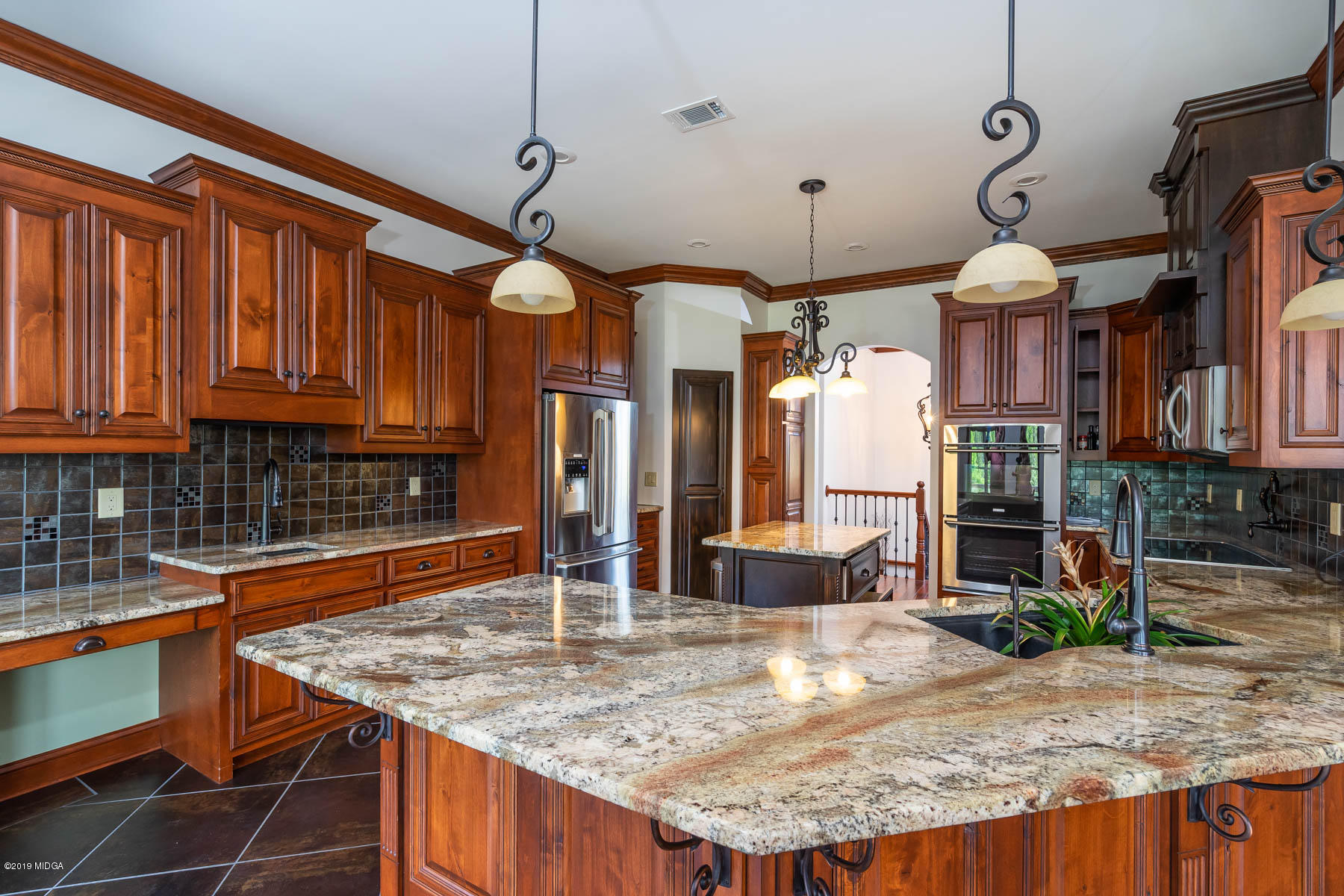 6331 Dobson Road Macon, GA 31220 - Photo 2 of 26 a kitchen with kitchen island granite countertop a table chairs and a wooden floor