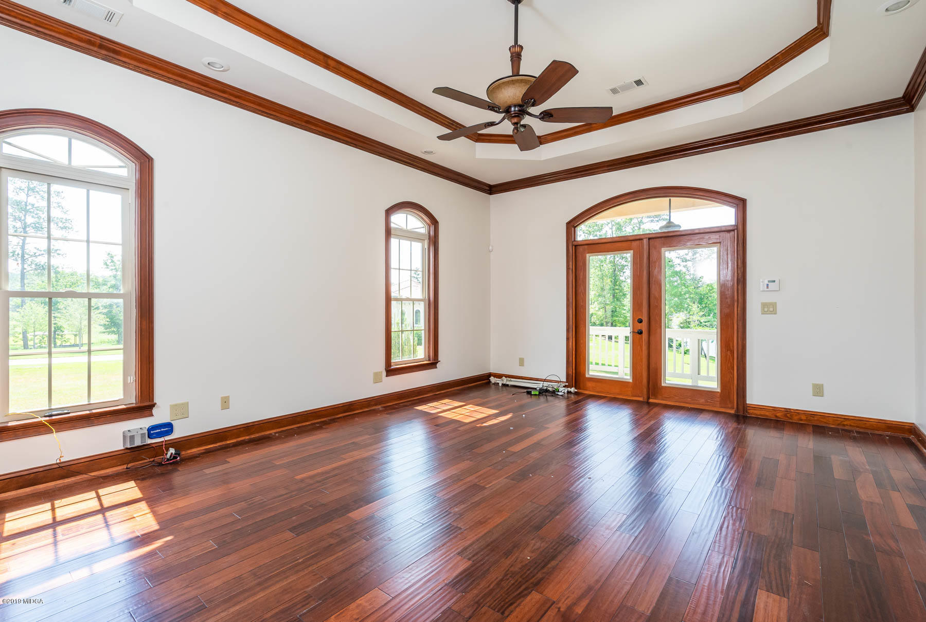 6331 Dobson Road Macon, GA 31220 - Photo 20 of 26 a view of an empty room with wooden floor and a window