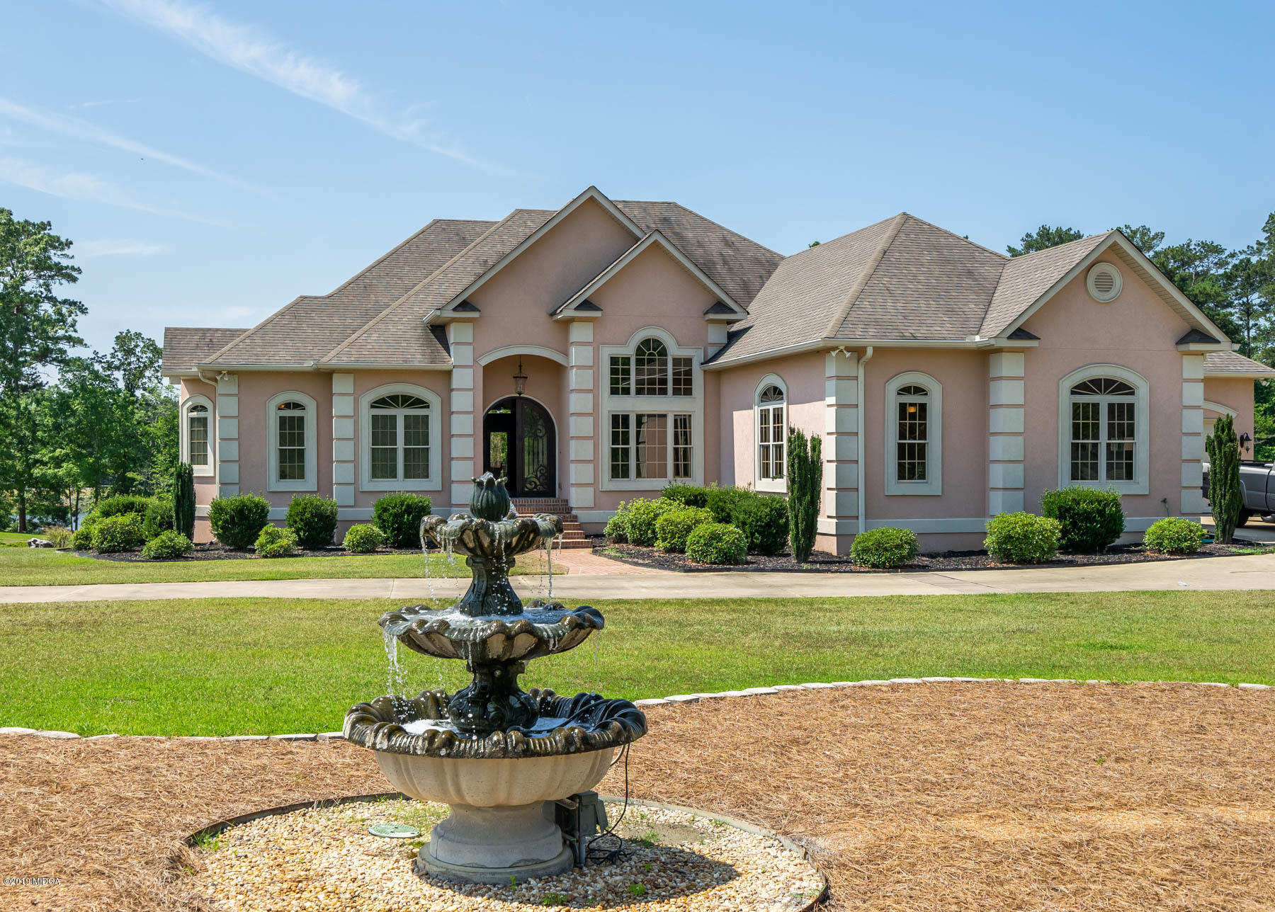 6331 Dobson Road Macon, GA 31220 - Photo 22 of 26 a front view of a house with a yard and potted plants
