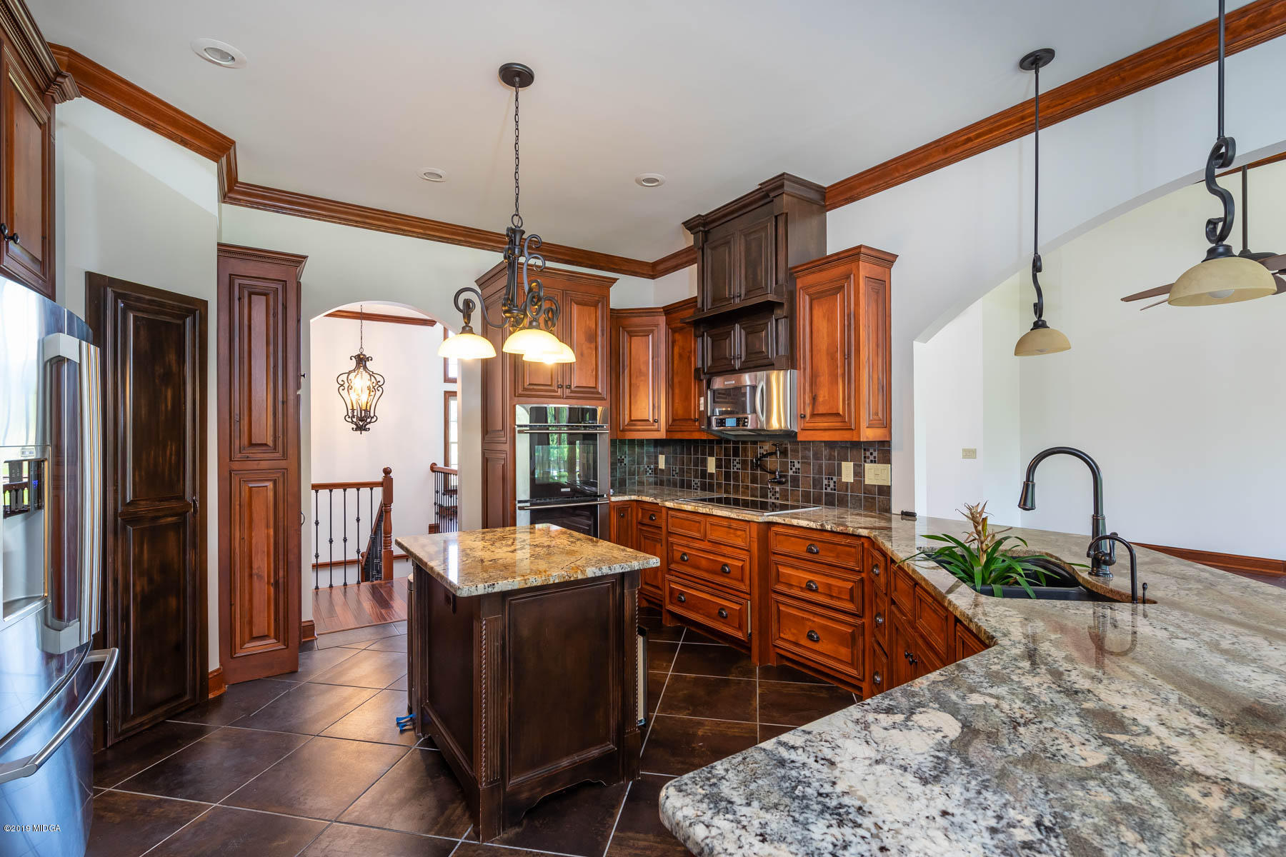 6331 Dobson Road Macon, GA 31220 - Photo 4 of 26 a kitchen with stainless steel appliances granite countertop sink stove and refrigerator