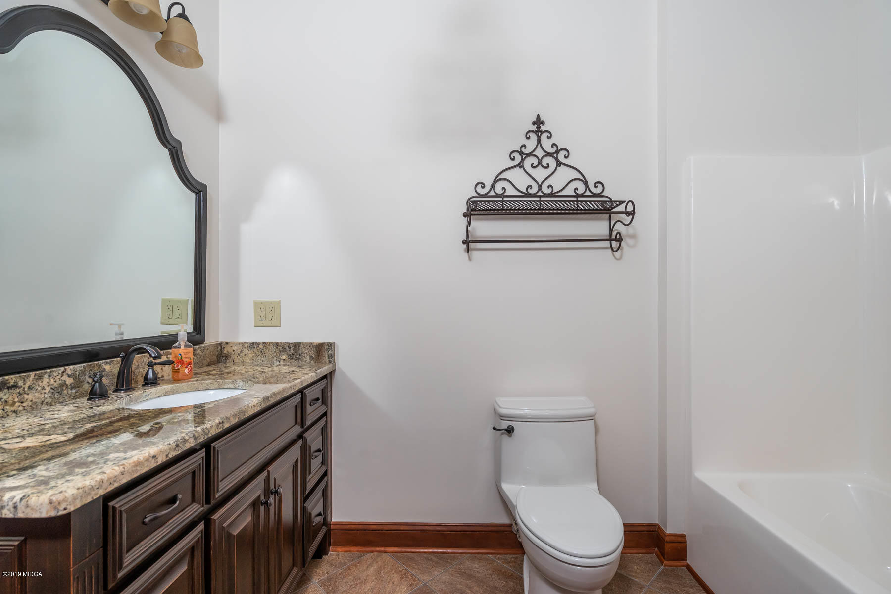 6331 Dobson Road Macon, GA 31220 - Photo 5 of 26 a bathroom with a granite countertop sink a toilet and shower