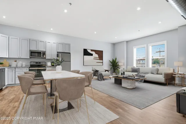 a living room with furniture a window and a table