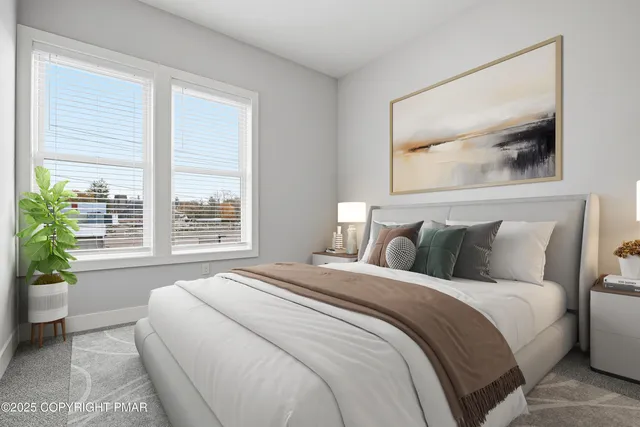 a bedroom with a large bed and a potted plant